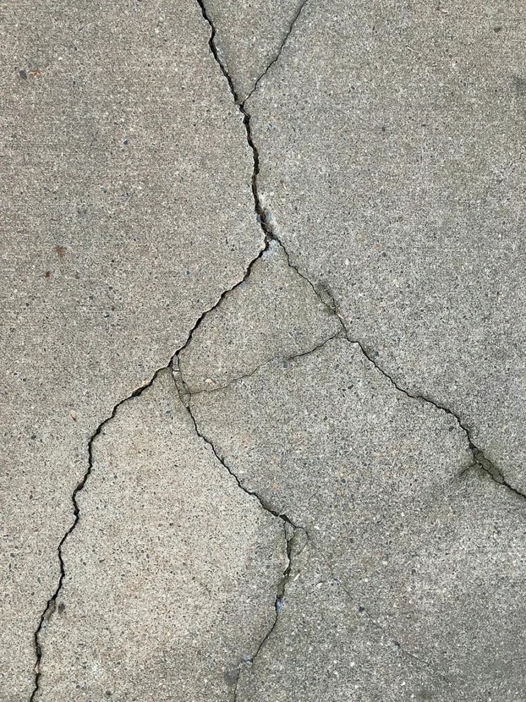 what causes cracks in concrete driveways
